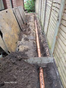 Continuation of pipework installation at side of house